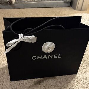 Chanel black shopping bag with white flower